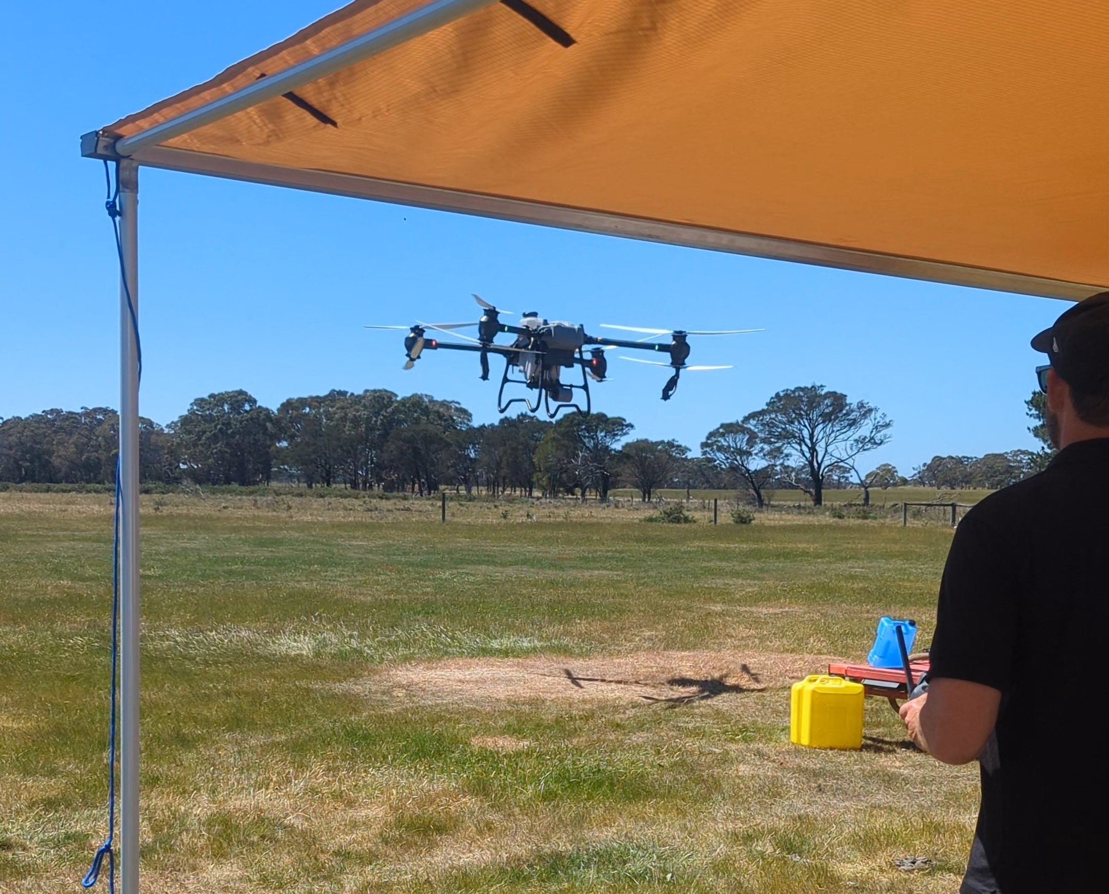 Storm Spatial licensed drone pilot operating DJI AGRAS spray drone over Victorian farmland — agricultural weed mapping and treatment drone operations. 